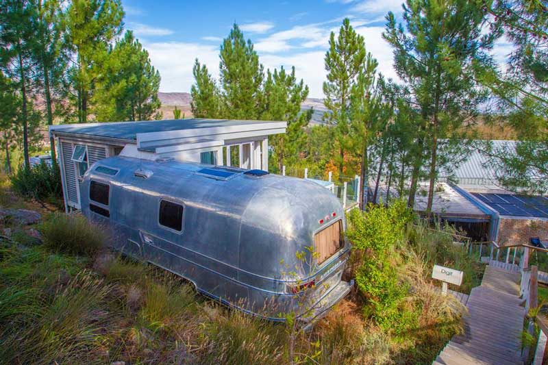 view of the back of an airstream unit looking at the restaurant and valley beyond