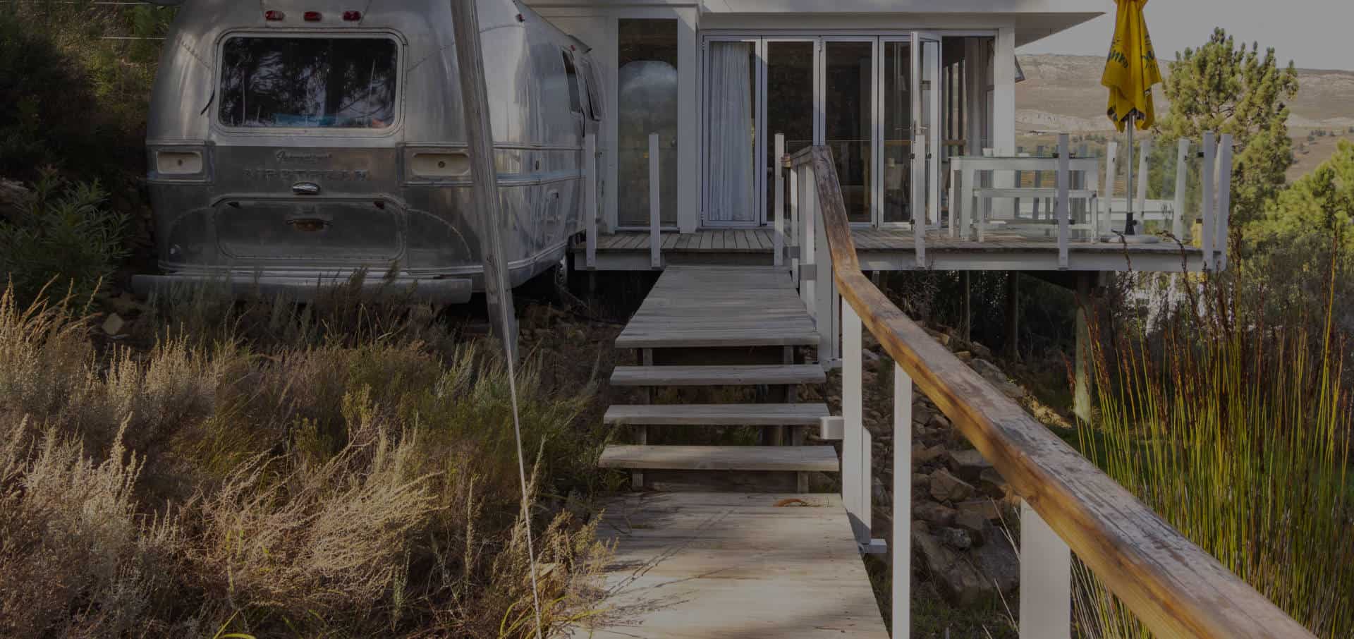 view of one of the airstream trailer accommodation units with the property in the background