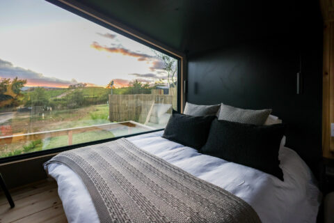 22: bed facing a wide picture window onto the valley at sunset, Old Mac Daddy, Elgin Valley