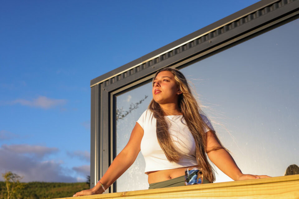 22: guest leaning in the big window frame in the evening sun, Old Mac Daddy, Elgin Valley