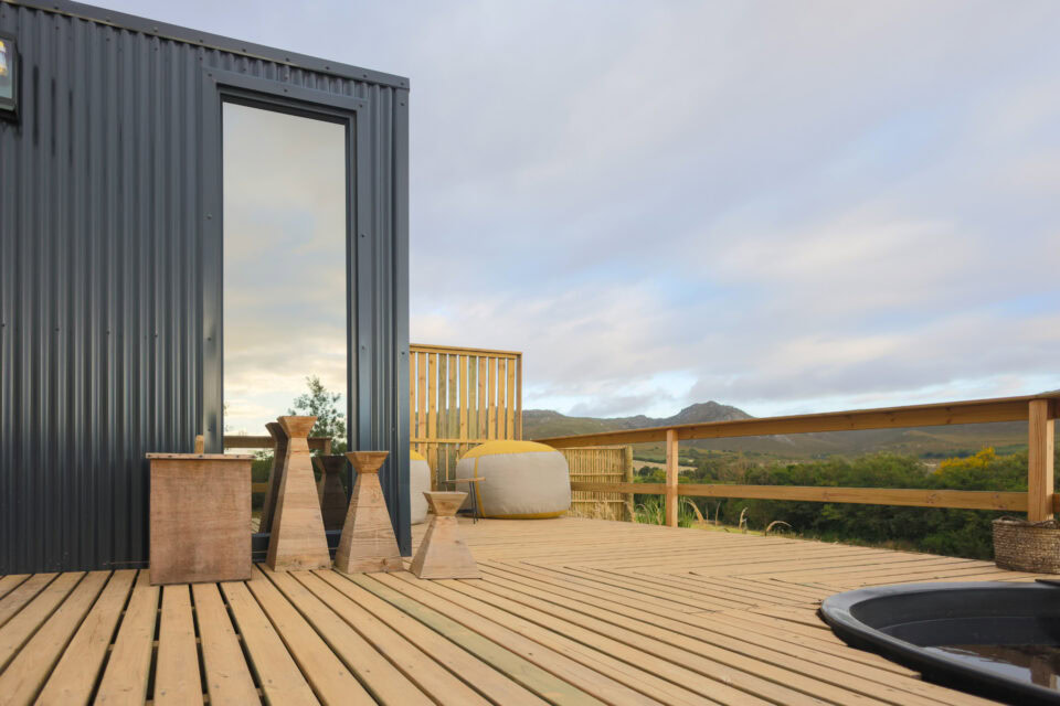 Aardvark: deck with a hot tub and stools, mountains beyond, Old Mac Daddy, Elgin Valley