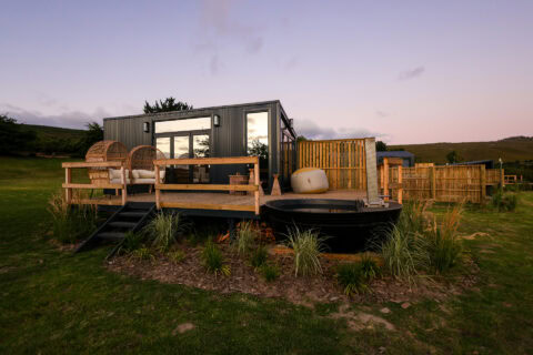 Aardvark: the unit at dusk, rattan chairs and a wood-fired hot tub on the deck, Old Mac Daddy, Elgin Valley