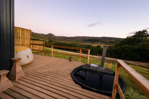 Aardvark: wood-fired hot tub on the deck overlooking the valley at dusk, Old Mac Daddy, Elgin Valley