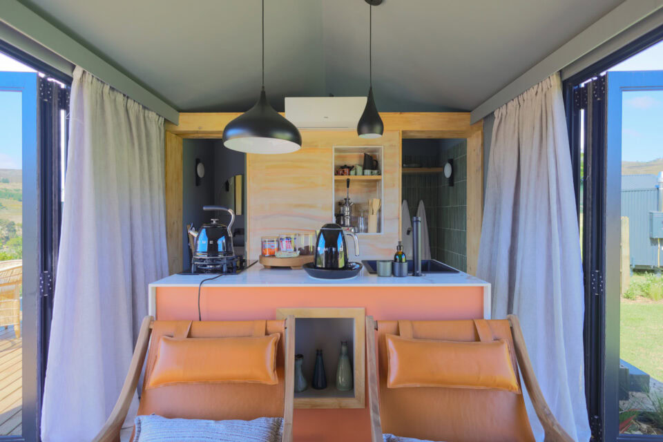 Asem: kitchenette with two orange leather chairs and pendant lights, Old Mac Daddy, Elgin Valley
