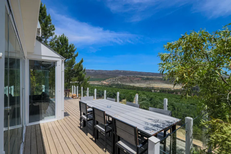 Daddy's Villa: long dining table on the deck above the valley and orchards, Old Mac Daddy, Elgin Valley