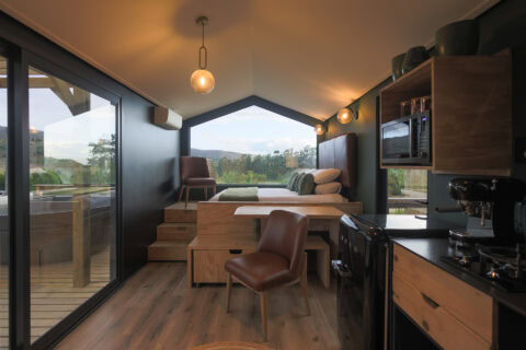 Intak: open-plan interior with a kitchenette, dining nook and a gabled window onto the hills, Old Mac Daddy, Elgin Valley