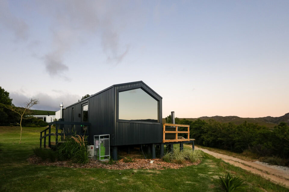 Intak: black gabled unit with a wide window, at dusk, Old Mac Daddy, Elgin Valley