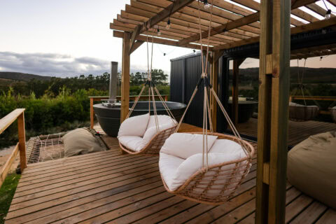Intak: hanging rattan chairs and a wood-fired hot tub under the deck pergola, Old Mac Daddy, Elgin Valley