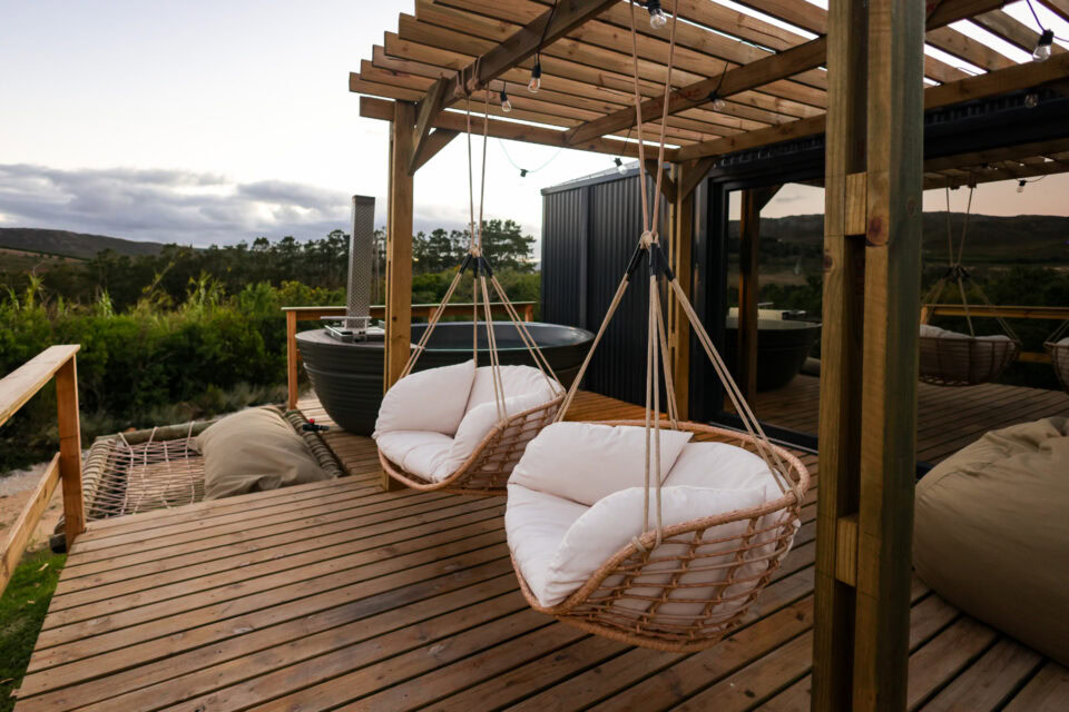 Intak: hanging rattan chairs and a wood-fired hot tub under the deck pergola, Old Mac Daddy, Elgin Valley
