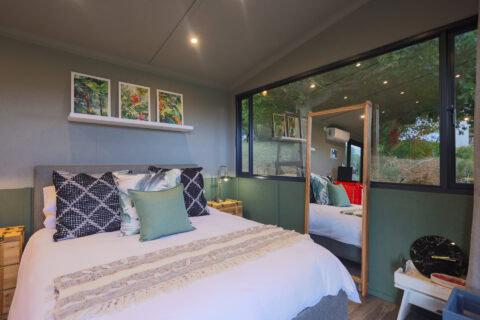Kaapse Nooi: double bed under three botanical prints, window onto the trees, Old Mac Daddy, Elgin Valley