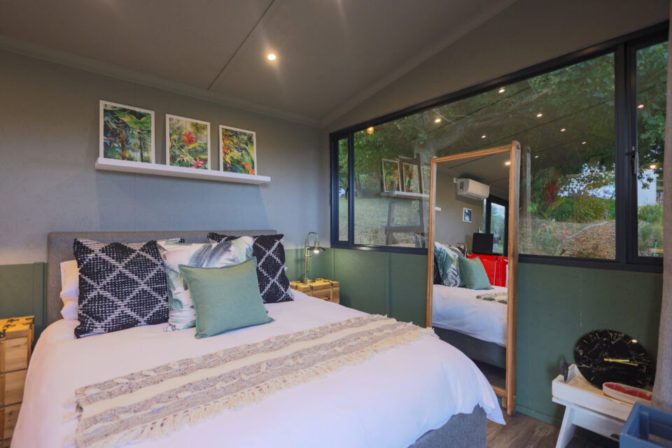 Kaapse Nooi: double bed under three botanical prints, window onto the trees, Old Mac Daddy, Elgin Valley