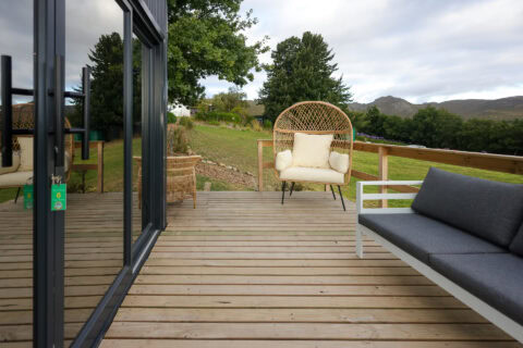 Kaapse Nooi: deck with a rattan egg chair and outdoor sofa, mountains behind, Old Mac Daddy, Elgin Valley