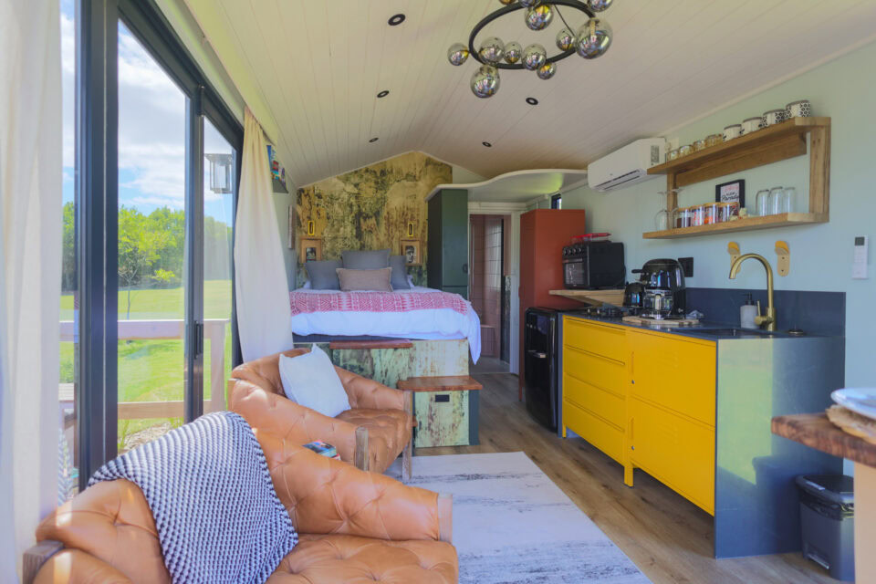 Palimpses: bed, leather armchairs and a yellow kitchenette in one open room, Old Mac Daddy, Elgin Valley