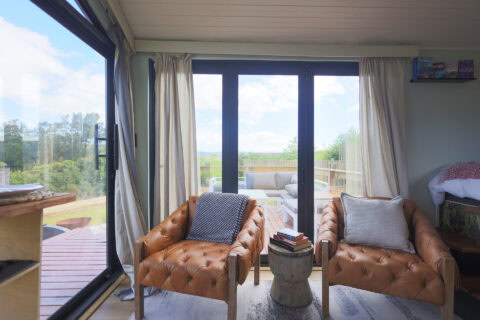 Palimpses: two buttoned leather armchairs by glass doors onto the deck, Old Mac Daddy, Elgin Valley