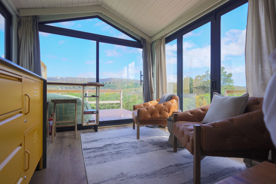 Palimpses: leather armchairs under a gabled glass wall onto the hills, Old Mac Daddy, Elgin Valley
