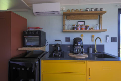 Palimpses: kitchenette with yellow cabinets, SMEG fridge and open shelves, Old Mac Daddy, Elgin Valley