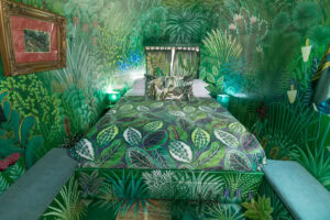 The Dream: bed with a leaf-print cover in a room painted with a jungle mural, Old Mac Daddy, Elgin Valley