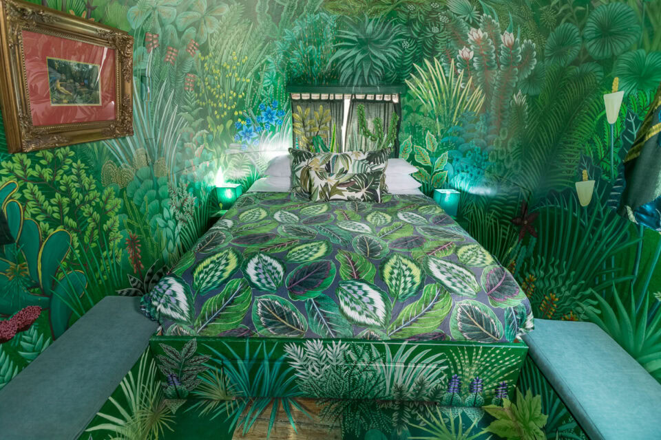 The Dream: bed with a leaf-print cover in a room painted with a jungle mural, Old Mac Daddy, Elgin Valley