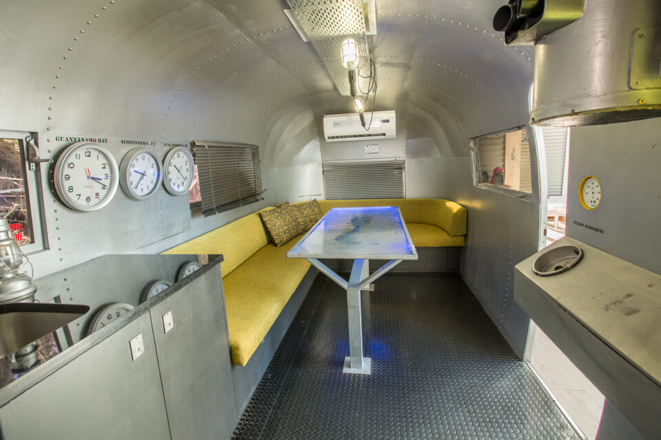 Yellow Submarine: submarine-themed Airstream with a yellow banquette, glass-topped table and wall clocks, Old Mac Daddy, Elgin Valley