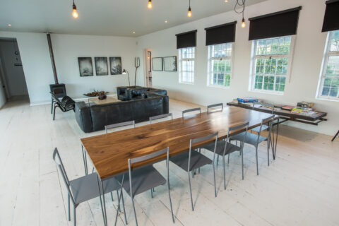 The School House: long dining table and leather sofas in the open-plan living room, Old Mac Daddy, Elgin Valley