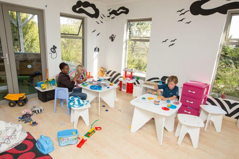 Children playing at small white tables in the kids' playroom, Old Mac Daddy, Elgin Valley