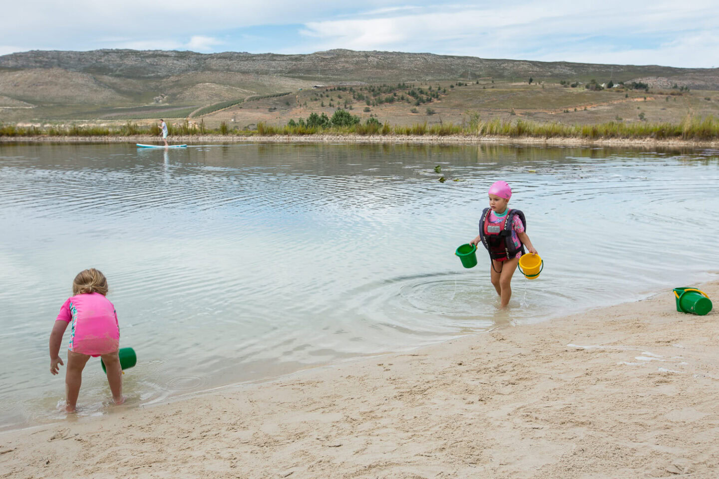 Two little girls with buckets playing at the edge of the lake, Old Mac Daddy, Elgin Valley
