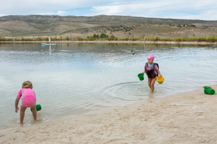 Two little girls with buckets playing at the edge of the lake, Old Mac Daddy, Elgin Valley