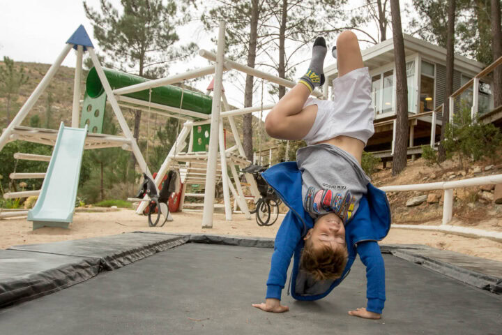 A boy doing a handstand on a trampoline by the playground, Old Mac Daddy, Elgin Valley