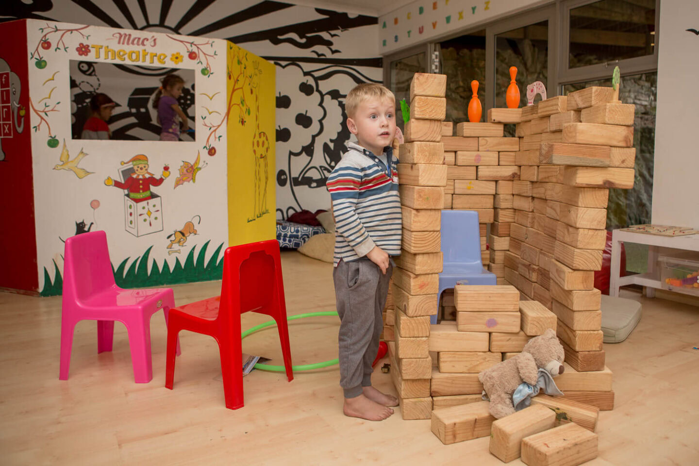 A little boy building with wooden blocks in the kids' playroom, Old Mac Daddy, Elgin Valley