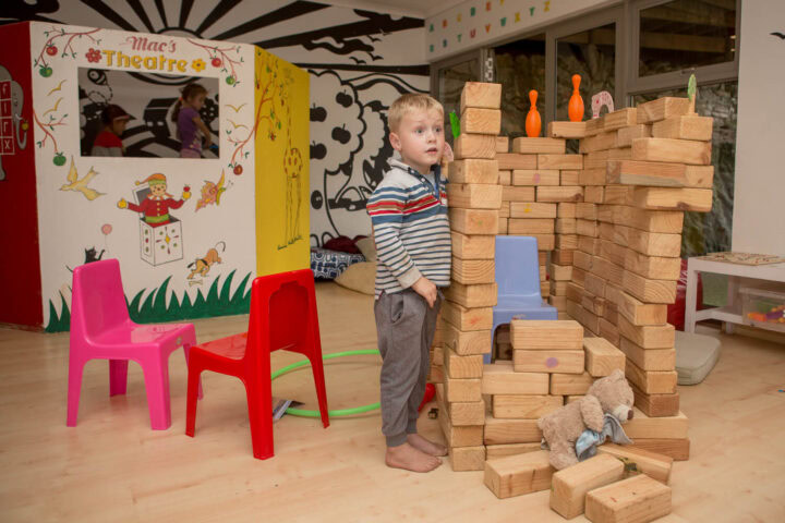 A little boy building with wooden blocks in the kids' playroom, Old Mac Daddy, Elgin Valley