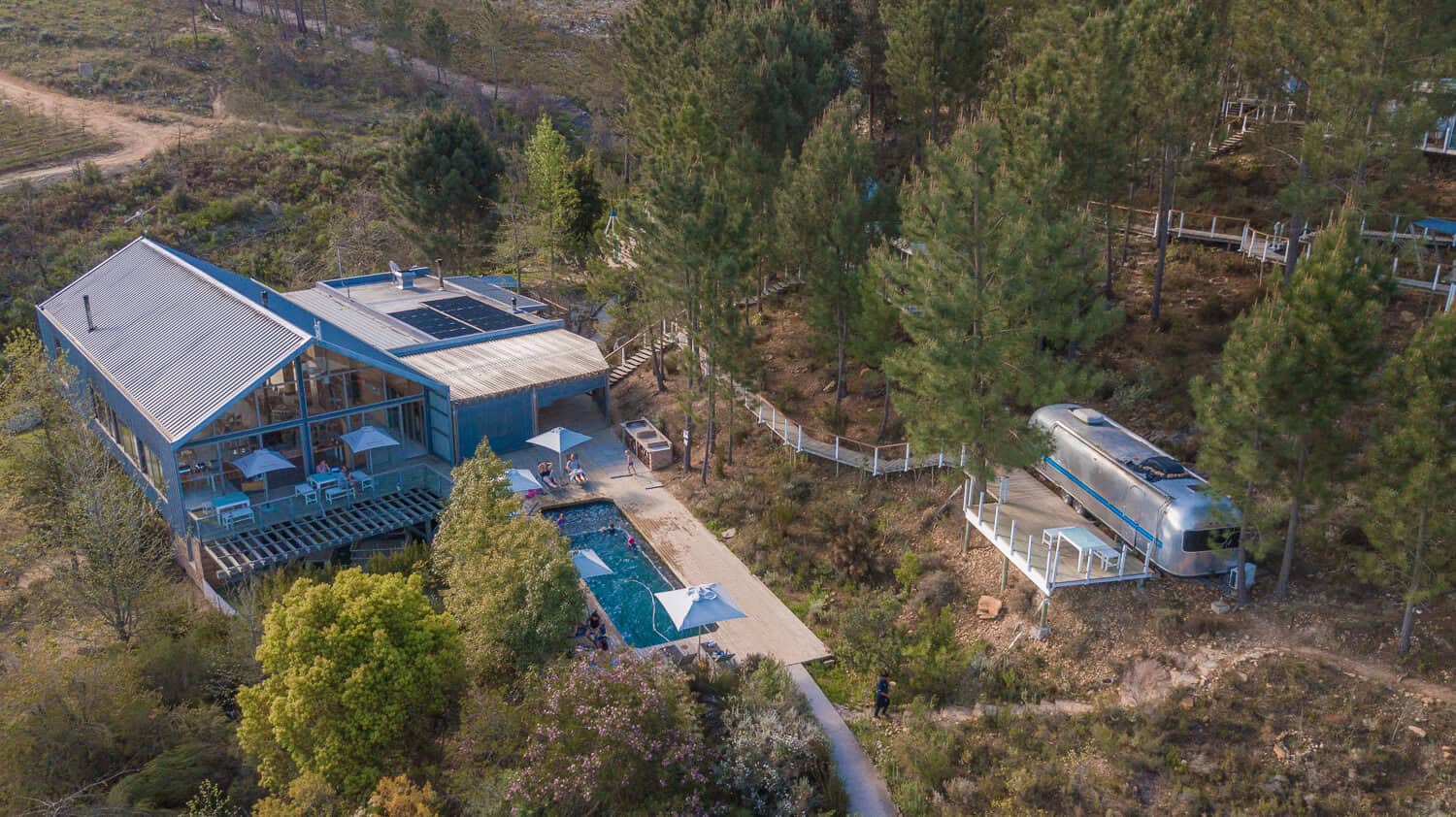 Aerial view of a villa with a pool and an Airstream among the trees, Old Mac Daddy, Elgin Valley