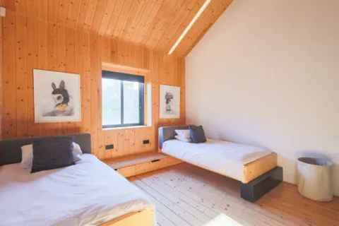 Apple Grove: twin bedroom with two single beds, pine walls and framed prints, Old Mac Daddy, Elgin Valley