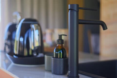close up view of kitchen counter with appliances inside asem tiny home