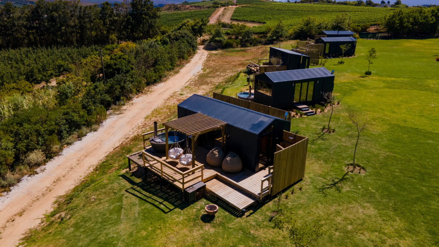 Klein Paradys: aerial view of units with decks and hot tubs along a gravel road, Old Mac Daddy, Elgin Valley