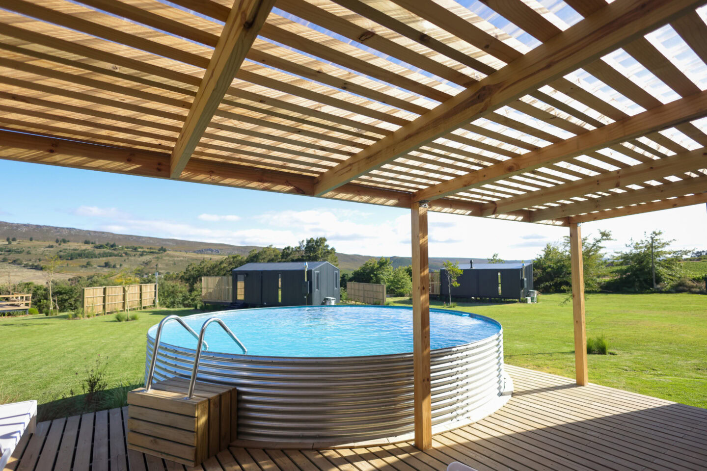 Klein Paradys: round steel plunge pool on a deck under a timber pergola, Old Mac Daddy, Elgin Valley