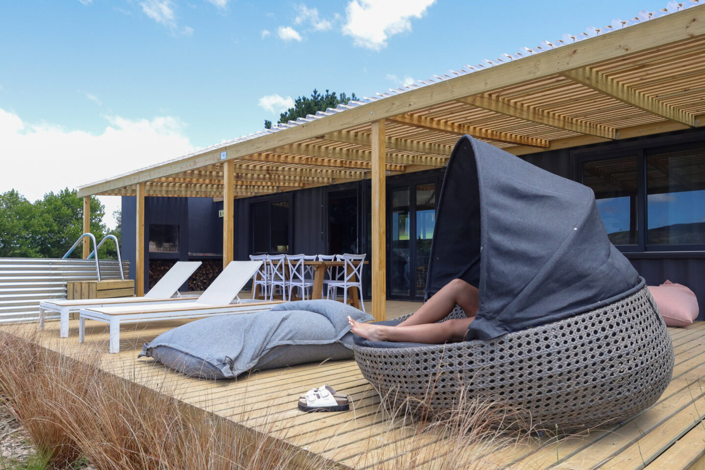 Klein Paradys: a guest relaxing in a hooded wicker lounger on the deck, Old Mac Daddy, Elgin Valley