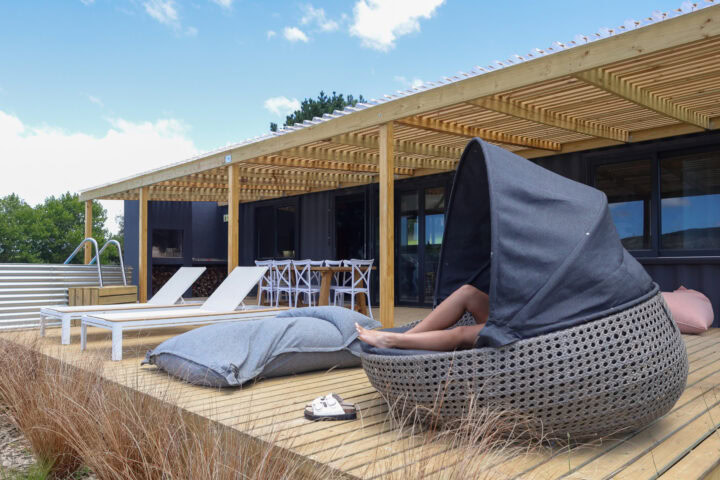 Klein Paradys: a guest relaxing in a hooded wicker lounger on the deck, Old Mac Daddy, Elgin Valley