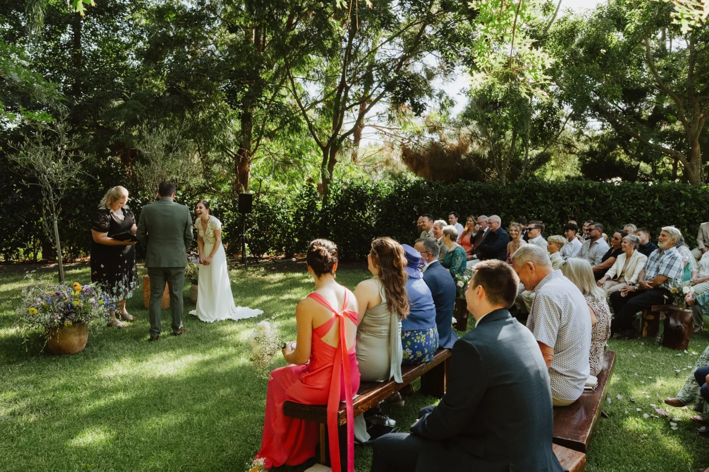 Guests seated on the lawn under the trees as the ceremony takes place at the front, Old Mac Daddy, Elgin Valley