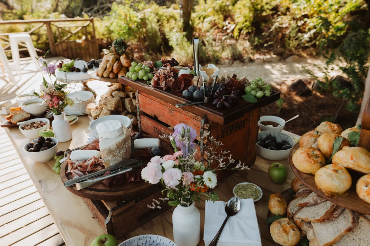 Grazing table of breads, fruit, cheeses and flowers laid out outdoors, Old Mac Daddy, Elgin Valley