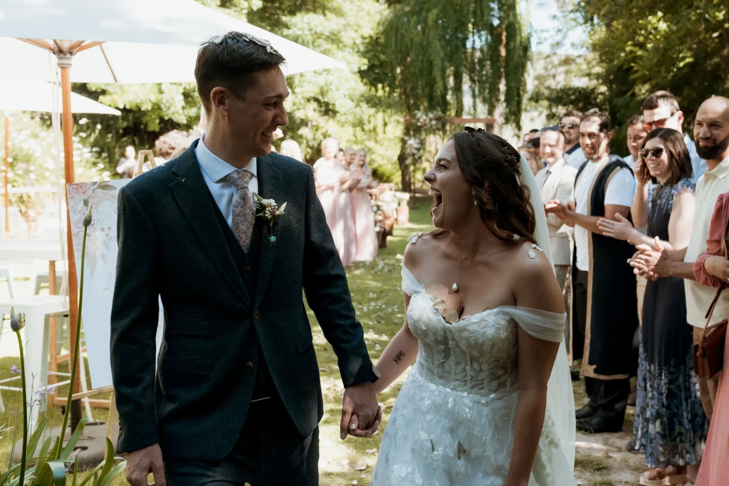 Bride and groom laughing as they walk back down the aisle between their guests, Old Mac Daddy, Elgin Valley