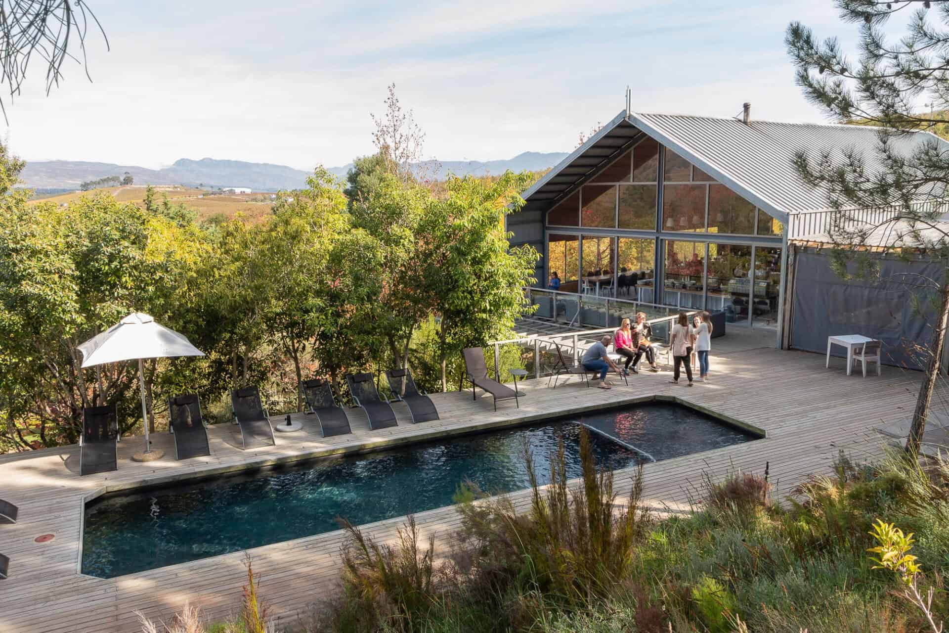 The Barn and its pool deck with guests and loungers, Old Mac Daddy, Elgin Valley
