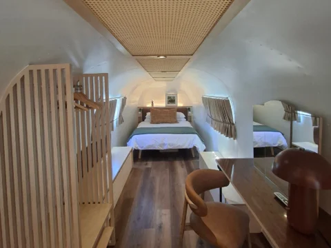 Sovereign 59: the bedroom end of the Airstream, with a plywood wardrobe and a desk under the cane ceiling, Old Mac Daddy, Elgin Valley