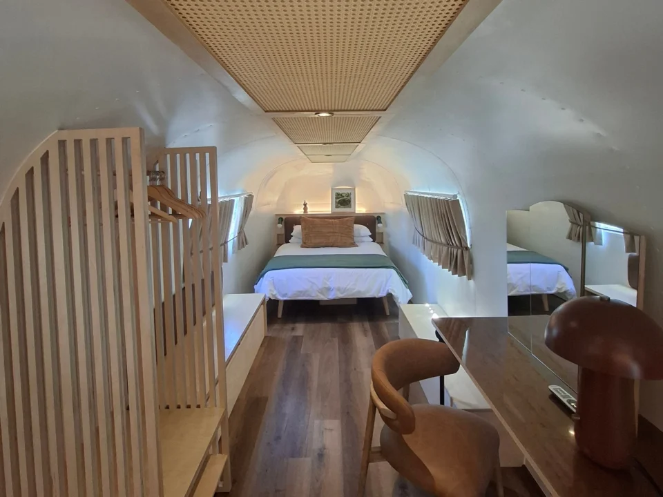 Sovereign 59: the bedroom end of the Airstream, with a plywood wardrobe and a desk under the cane ceiling, Old Mac Daddy, Elgin Valley