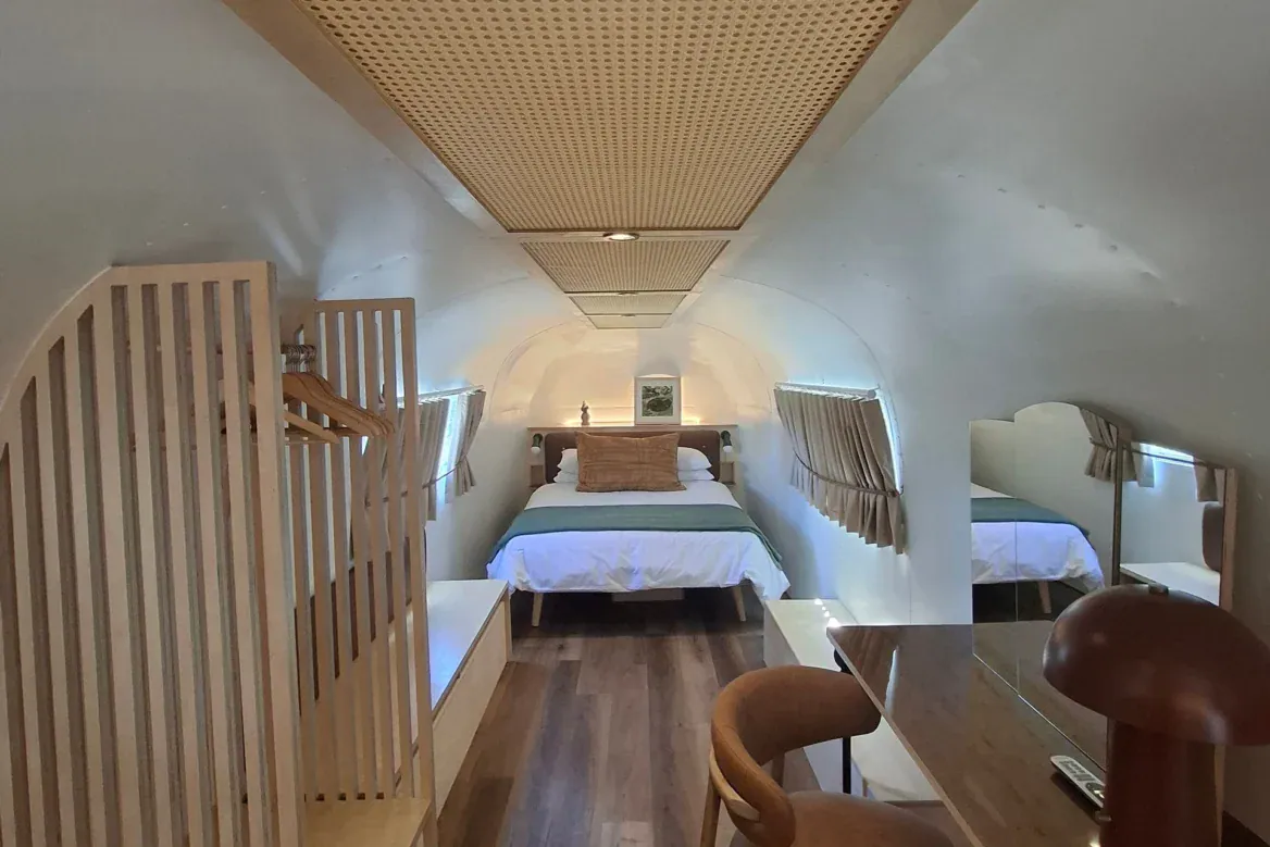 Sovereign 59: the bedroom end of the Airstream, with a plywood wardrobe and a desk under the cane ceiling, Old Mac Daddy, Elgin Valley