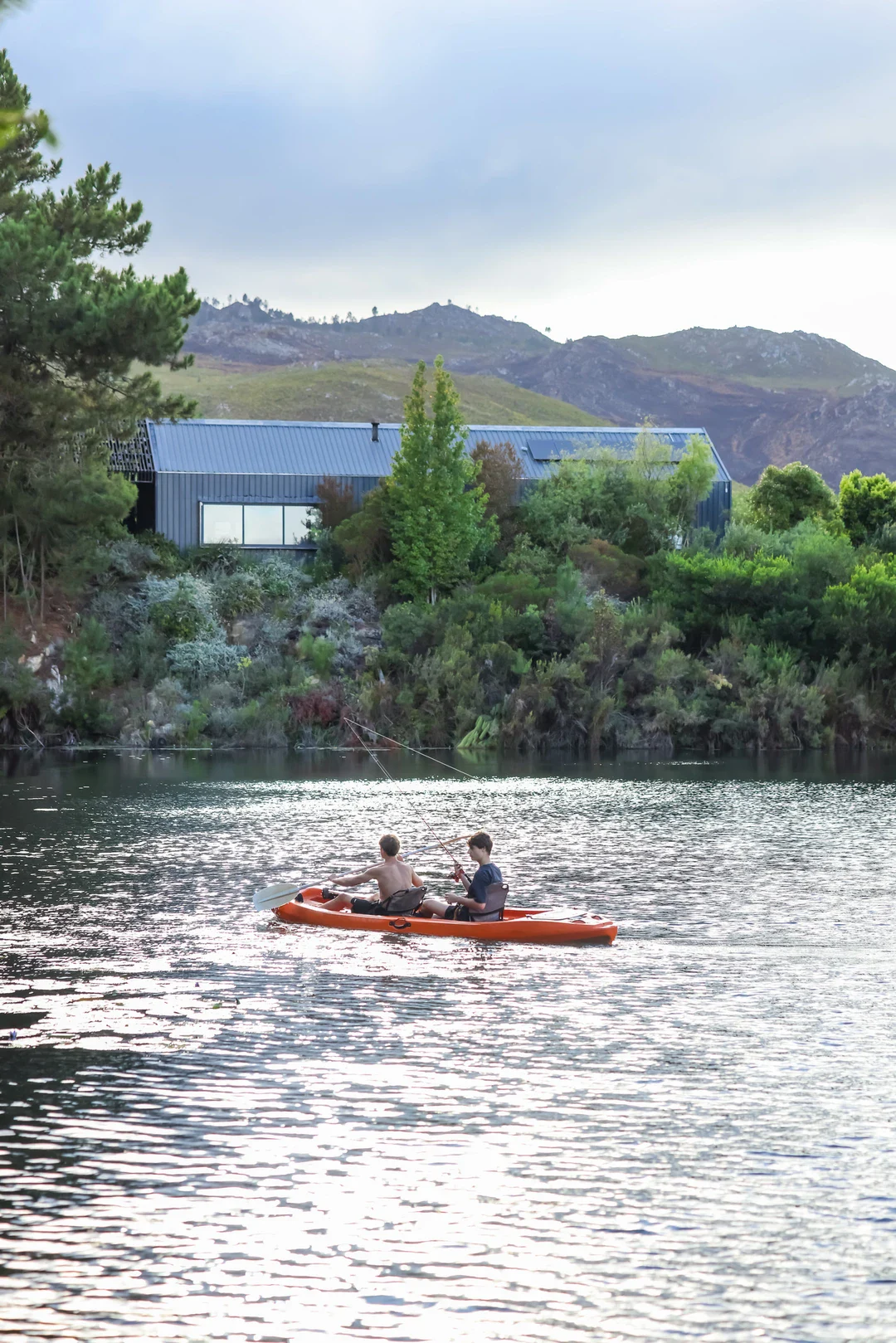 Team Building Adults kayaking with the lodge on the shore, Old Mac Daddy, Elgin Valley