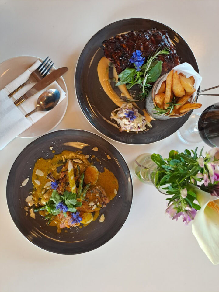 Two plated main courses on a white table, seen from above, Old Mac Daddy, Elgin Valley