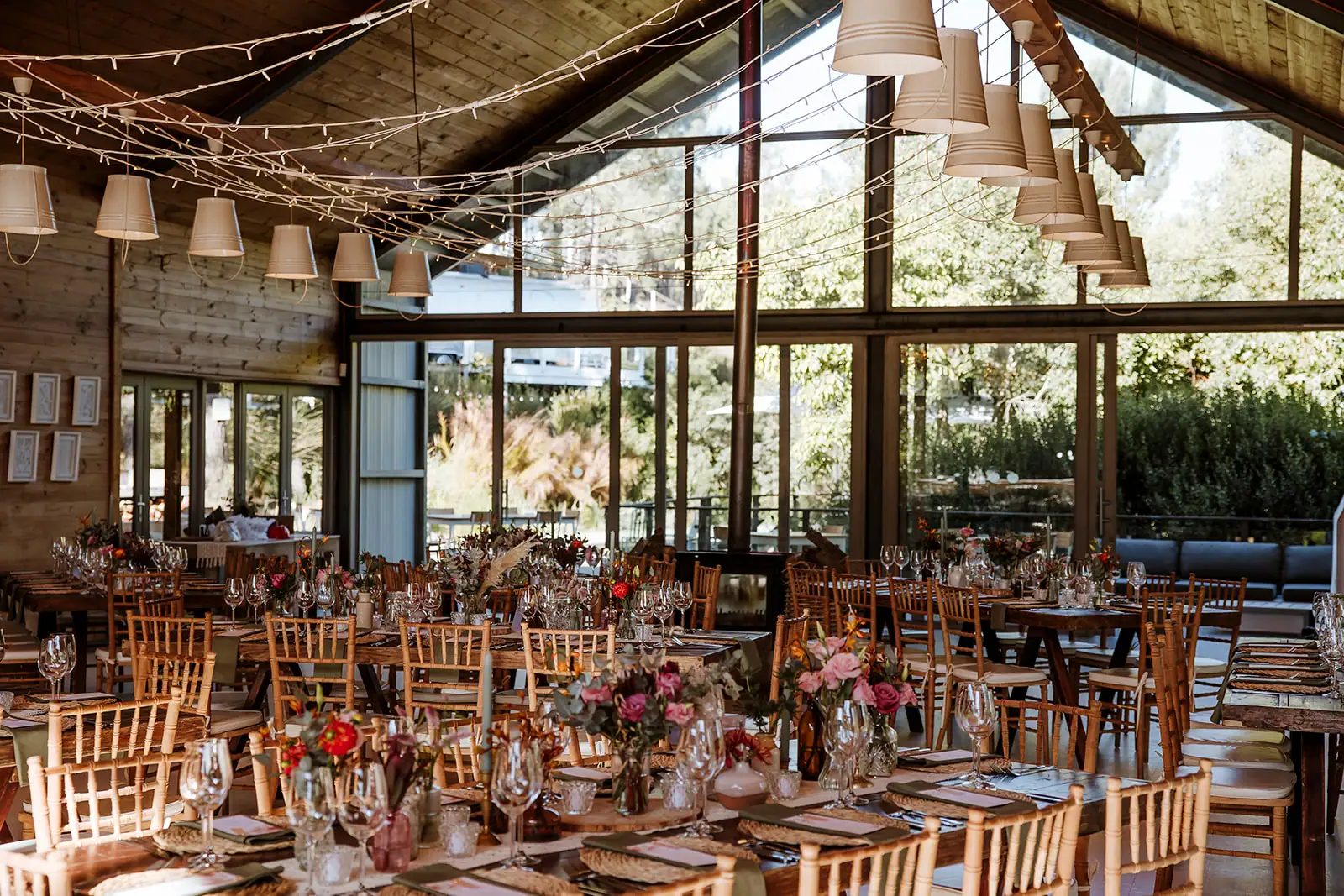 Weddings & Events The Barn set for a wedding reception: long tables with flowers and candles under a canopy of fairy lights, Old Mac Daddy, Elgin Valley