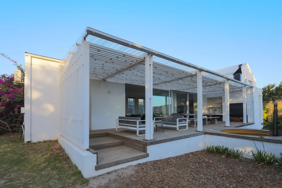 The School House: white gabled house with a slatted pergola over the patio and outdoor seating, Old Mac Daddy, Elgin Valley