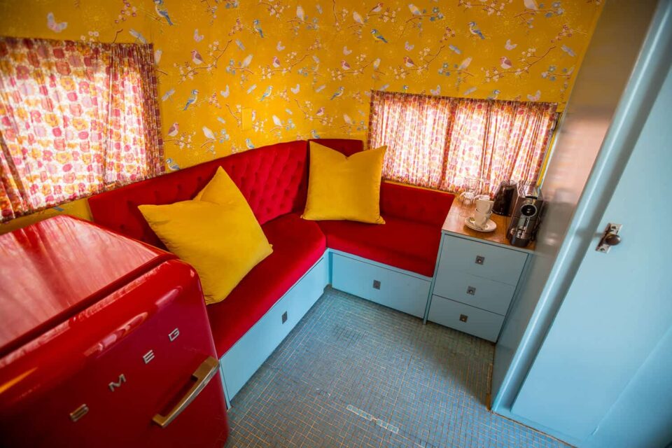 Birdy: red banquette with yellow cushions, bird-print wallpaper and a red SMEG fridge, Old Mac Daddy, Elgin Valley