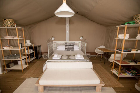 Daddy's Hideaway: tented bedroom with a double bed and open shelving, Old Mac Daddy, Elgin Valley